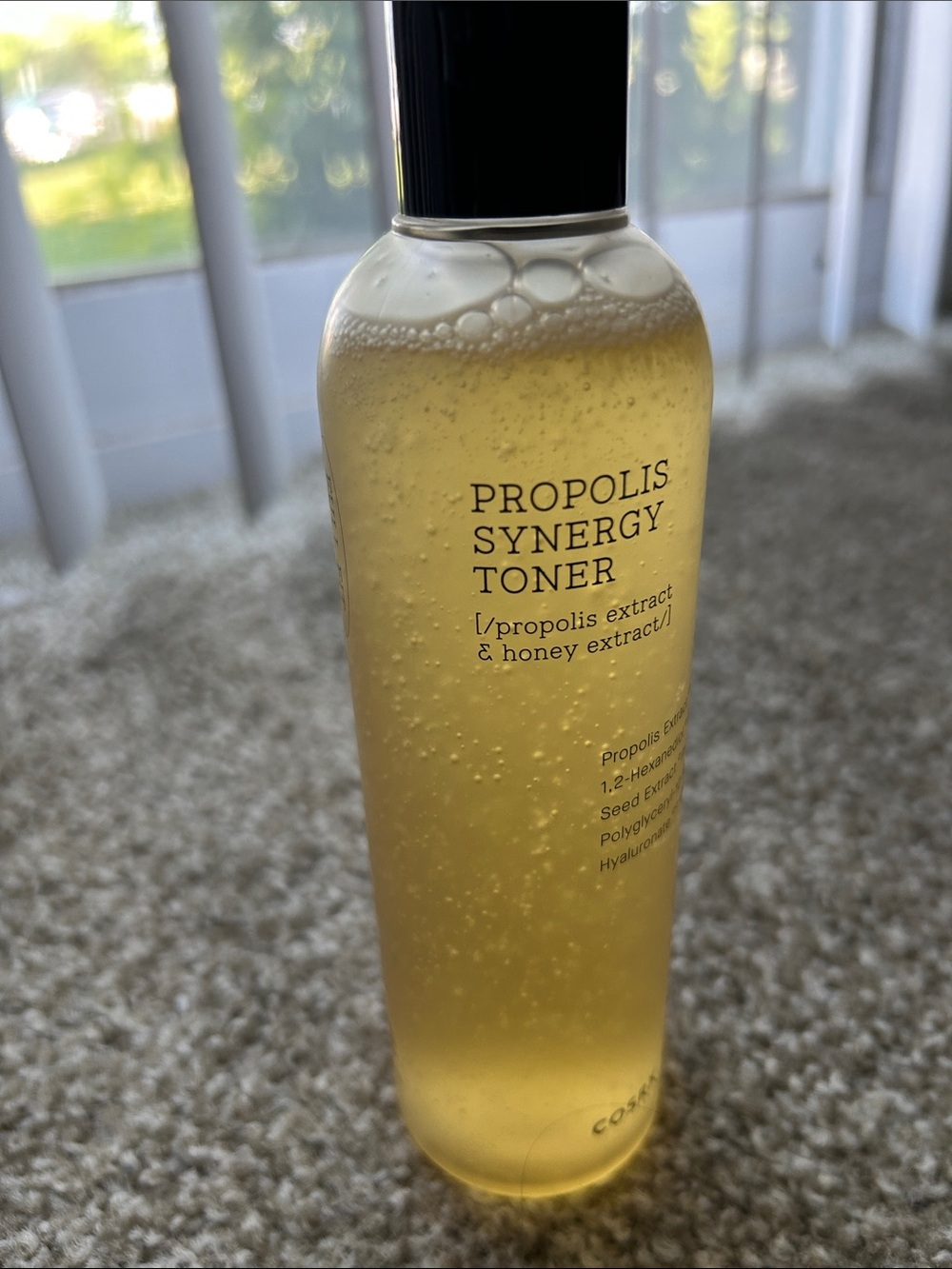 COS Propolis Toner in Honey-Gold with Black Cap